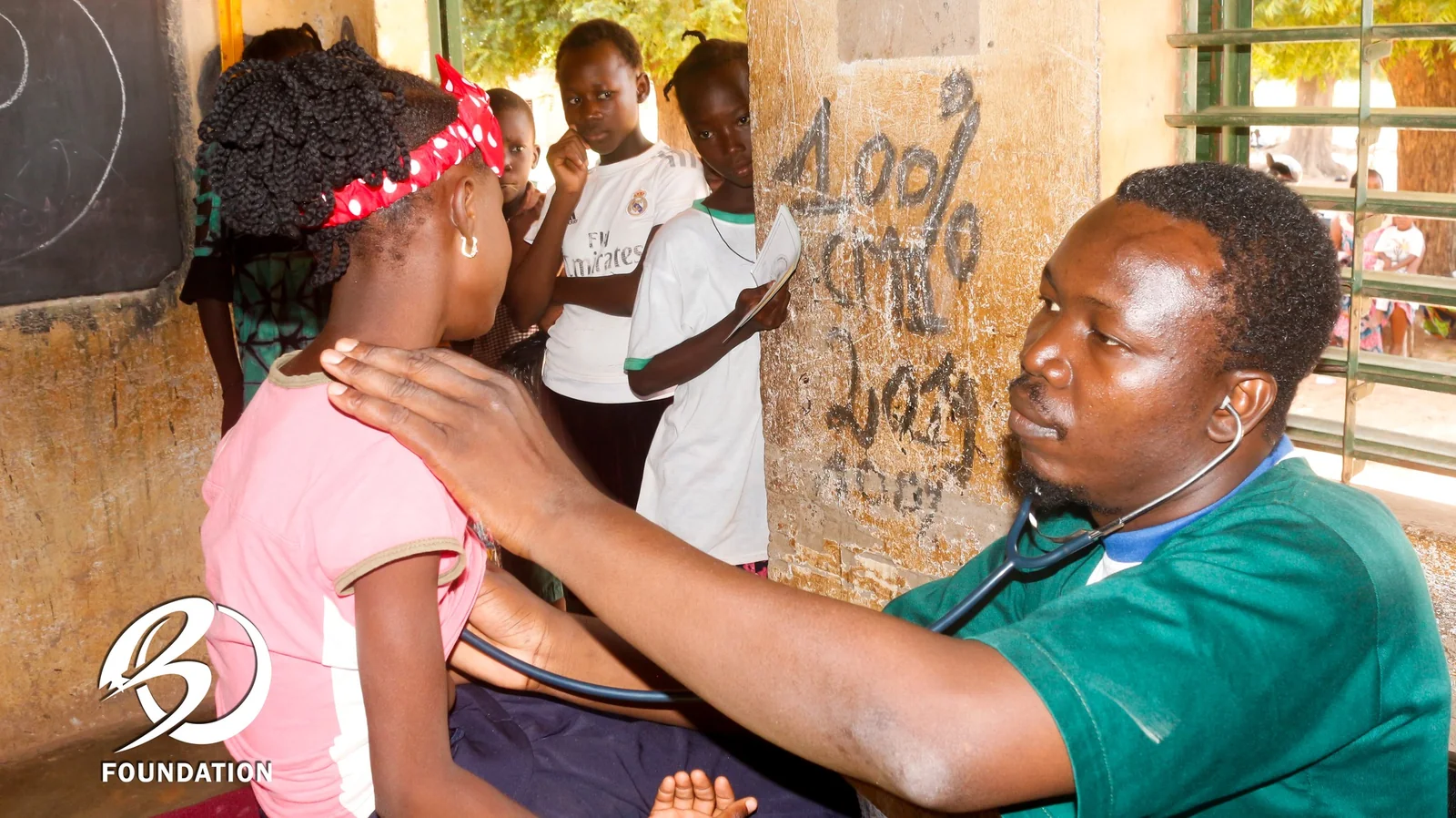 A health professional examining a child at school.